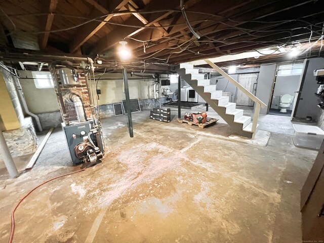 55 Lancaster St, Watertown, CT 06779 - below grade area with stairs, healthy amount of natural light, and a heating unit