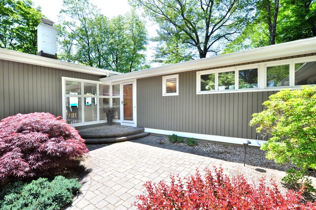 29 Montevideo Rd, Avon, CT 06001 - doorway to property featuring a chimney and a patio