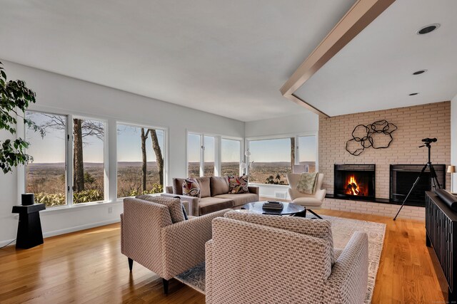 29 Montevideo Rd, Avon, CT 06001 - living room with a brick fireplace, healthy amount of natural light, and light wood finished floors