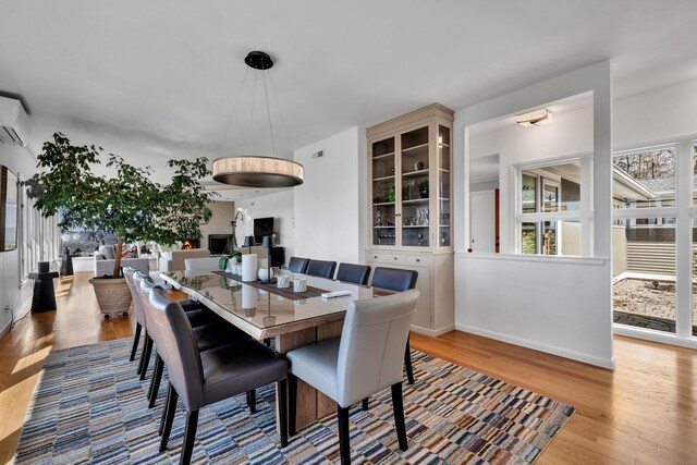 29 Montevideo Rd, Avon, CT 06001 - dining space with wood finished floors, a wall unit AC, and baseboards