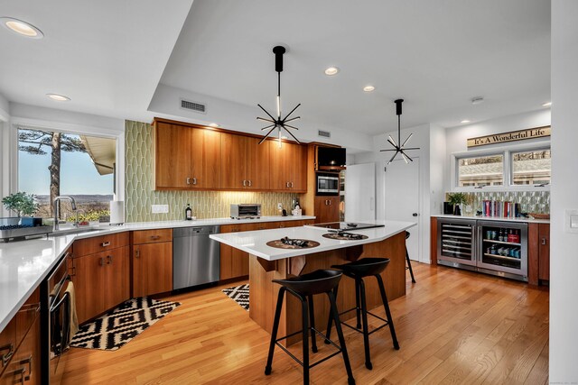 29 Montevideo Rd, Avon, CT 06001 - kitchen featuring stainless steel appliances, wine cooler, a sink, light wood-style floors, and recessed lighting