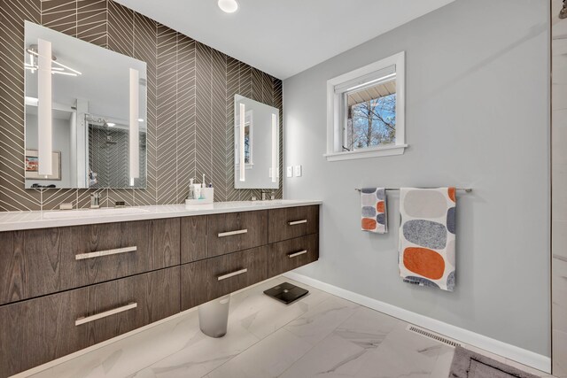 29 Montevideo Rd, Avon, CT 06001 - bathroom featuring an accent wall, baseboards, double vanity, wallpapered walls, and marble finish flooring