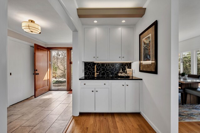 29 Montevideo Rd, Avon, CT 06001 - kitchen with dark countertops, backsplash, white cabinets, light wood finished floors, and recessed lighting