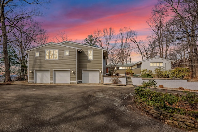 29 Montevideo Rd, Avon, CT 06001 - property exterior at dusk with a garage and driveway