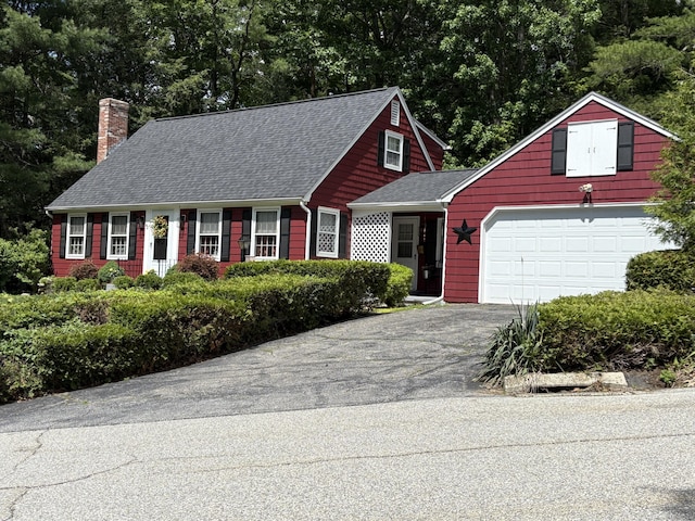 42 Sycamore Ter, Windham, CT 06280 - view of front of house with a chimney, driveway, roof with shingles, and view of scattered trees