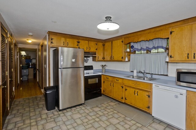 42 Sycamore Ter, Windham, CT 06280 - kitchen with appliances with stainless steel finishes, under cabinet range hood, light countertops, brick patterned floors, and brown cabinets