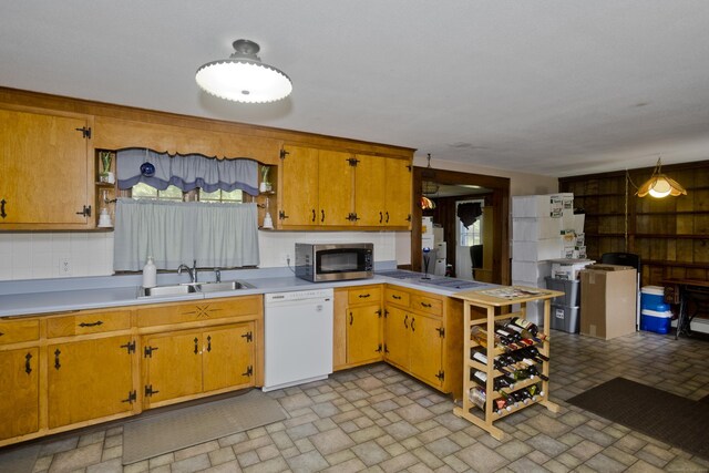 42 Sycamore Ter, Windham, CT 06280 - kitchen with dishwasher, stainless steel microwave, brick patterned floors, light countertops, and decorative backsplash