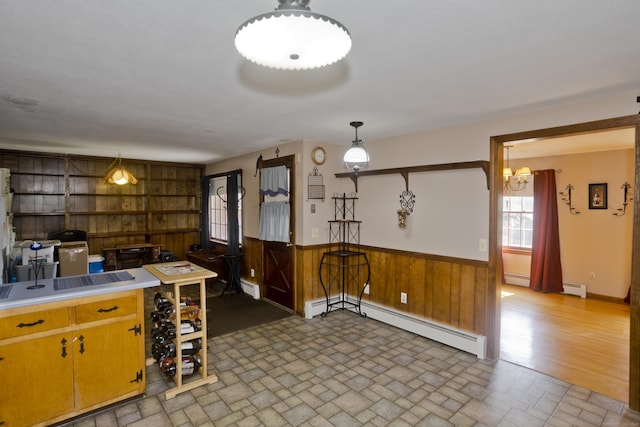 42 Sycamore Ter, Windham, CT 06280 - kitchen with baseboard heating, wood walls, wainscoting, a chandelier, and a baseboard heating unit