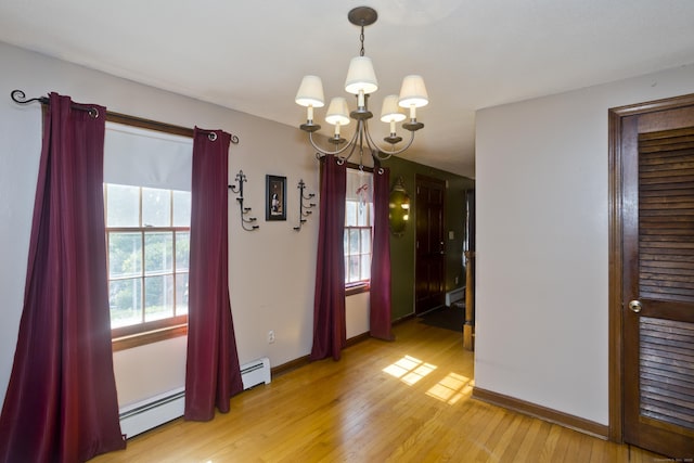 42 Sycamore Ter, Windham, CT 06280 - unfurnished dining area with a chandelier, light wood-type flooring, and a baseboard heating unit