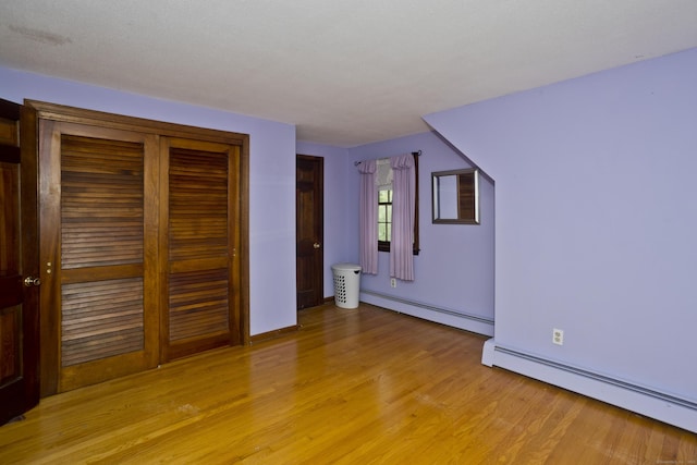 42 Sycamore Ter, Windham, CT 06280 - unfurnished bedroom featuring a baseboard radiator, light wood-style floors, and a closet