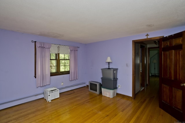 42 Sycamore Ter, Windham, CT 06280 - unfurnished room with light wood-type flooring, baseboard heating, and a baseboard radiator