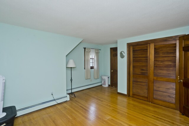42 Sycamore Ter, Windham, CT 06280 - unfurnished bedroom with baseboard heating, light wood-style floors, and a closet