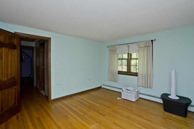 42 Sycamore Ter, Windham, CT 06280 - spare room featuring light wood finished floors and a baseboard heating unit