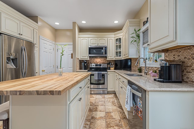 59 Woodbine Rd, Colchester, CT 06415 - kitchen with appliances with stainless steel finishes, a sink, butcher block countertops, tasteful backsplash, and recessed lighting