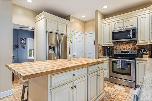 59 Woodbine Rd, Colchester, CT 06415 - kitchen featuring stainless steel appliances, decorative backsplash, butcher block counters, recessed lighting, and a kitchen island