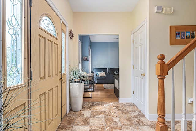59 Woodbine Rd, Colchester, CT 06415 - foyer entrance featuring healthy amount of natural light, stairs, baseboards, and light stone finish flooring