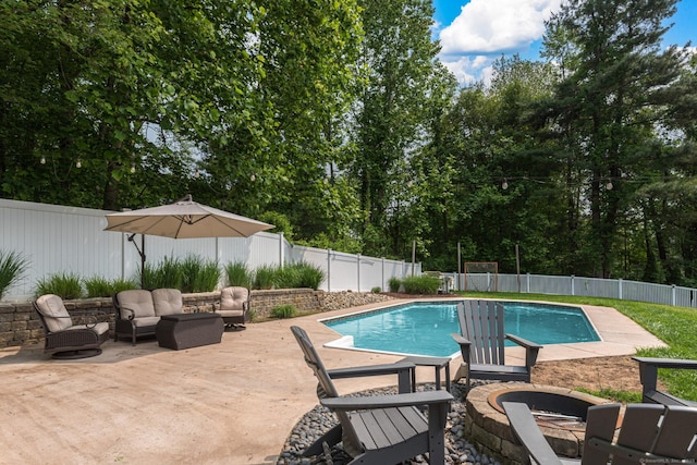 59 Woodbine Rd, Colchester, CT 06415 - view of swimming pool with a fenced backyard, an outdoor living space with a fire pit, a patio area, and view of wooded area