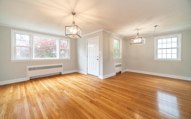 43 Breyer Ave, Bridgeport, CT 06606 - unfurnished dining area with a chandelier, radiator, ornamental molding, and light wood-type flooring