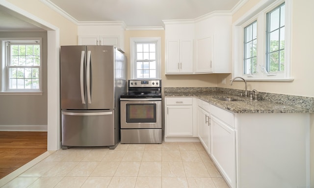43 Breyer Ave, Bridgeport, CT 06606 - kitchen featuring appliances with stainless steel finishes, a sink, dark stone countertops, white cabinetry, and crown molding