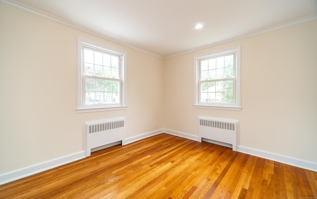 43 Breyer Ave, Bridgeport, CT 06606 - unfurnished room featuring radiator, baseboards, light wood finished floors, ornamental molding, and recessed lighting