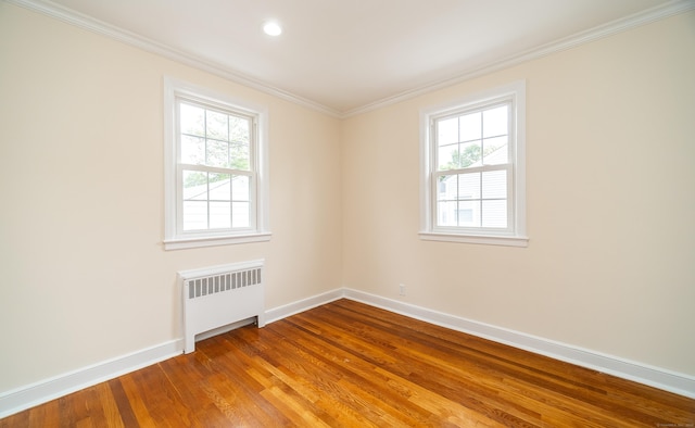 43 Breyer Ave, Bridgeport, CT 06606 - empty room with radiator heating unit, baseboards, wood finished floors, crown molding, and recessed lighting