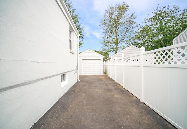 43 Breyer Ave, Bridgeport, CT 06606 - view of yard featuring an outbuilding, asphalt driveway, and a detached garage