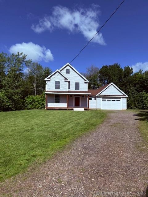 15 Suffield St, Windsor Locks, CT 06096 - view of front of home with driveway, a garage, a front lawn, and a porch
