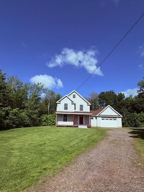 15 Suffield St, Windsor Locks, CT 06096 - view of front of house with dirt driveway, covered porch, and a front lawn