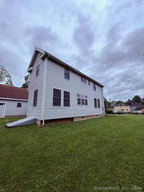 15 Suffield St, Windsor Locks, CT 06096 - rear view of house featuring a yard