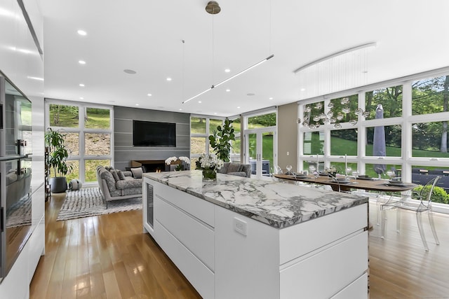 326 Georgetown Rd, Weston, CT 06883 - kitchen with modern cabinets, white cabinetry, plenty of natural light, wood-type flooring, and a wall of windows