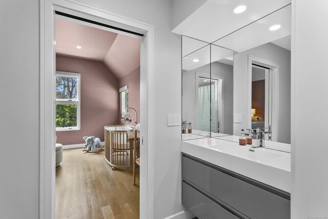 326 Georgetown Rd, Weston, CT 06883 - bathroom featuring wood finished floors, lofted ceiling, vanity, baseboards, and recessed lighting