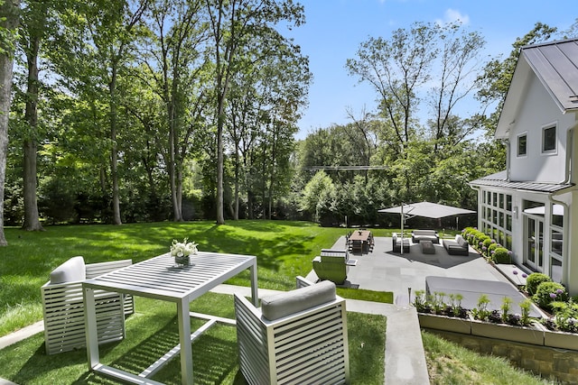 326 Georgetown Rd, Weston, CT 06883 - view of grassy yard with an outdoor hangout area, a patio, and view of wooded area