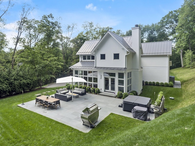 326 Georgetown Rd, Weston, CT 06883 - back of property featuring french doors, a standing seam roof, a patio area, outdoor lounge area, and a chimney