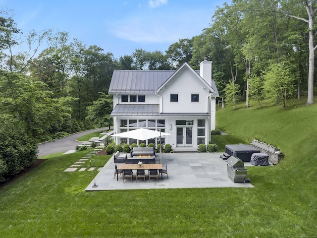 326 Georgetown Rd, Weston, CT 06883 - back of house featuring an outdoor hangout area, a chimney, a patio, a standing seam roof, and french doors