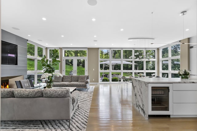 326 Georgetown Rd, Weston, CT 06883 - living area with beverage cooler, recessed lighting, a fireplace, light wood-style flooring, and french doors