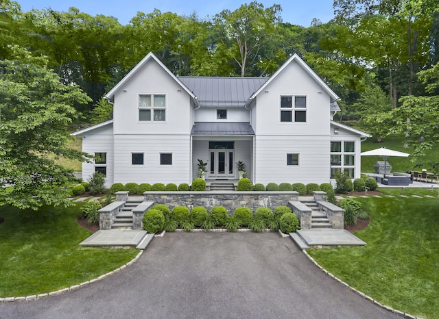 326 Georgetown Rd, Weston, CT 06883 - rear view of house featuring a standing seam roof, a yard, and metal roof