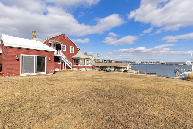 209 Pequot Ave, New London, CT 06320 - rear view of property featuring a chimney, a water view, stairs, and a yard