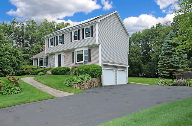 43 Redwood Cir, Shelton, CT 06484 - colonial home with an attached garage, asphalt driveway, and a front lawn