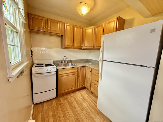 14 Arrowhead Way Apt C6, Woodbury, CT 06798 - kitchen with white appliances, a sink, light wood finished floors, light countertops, and decorative backsplash