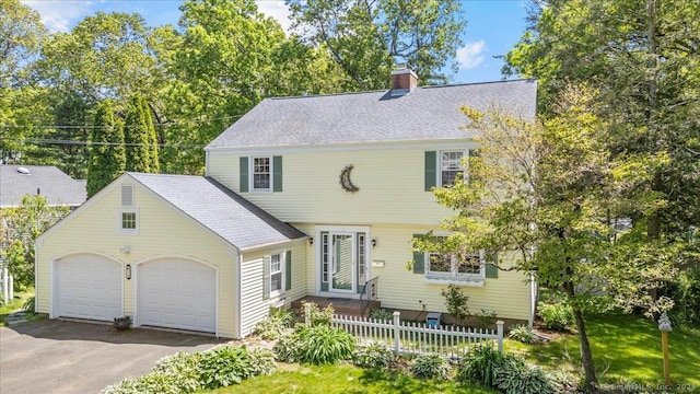 18 Hillcrest Rd, Manchester, CT 06040 - colonial-style house with a chimney, an attached garage, asphalt driveway, and roof with shingles