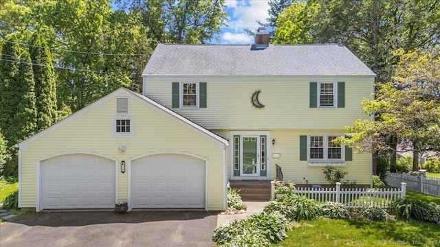 18 Hillcrest Rd, Manchester, CT 06040 - colonial inspired home featuring driveway, a chimney, an attached garage, and a shingled roof