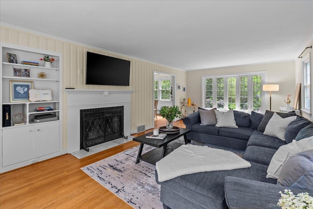 18 Hillcrest Rd, Manchester, CT 06040 - living area with crown molding, a fireplace with flush hearth, plenty of natural light, and light wood-type flooring