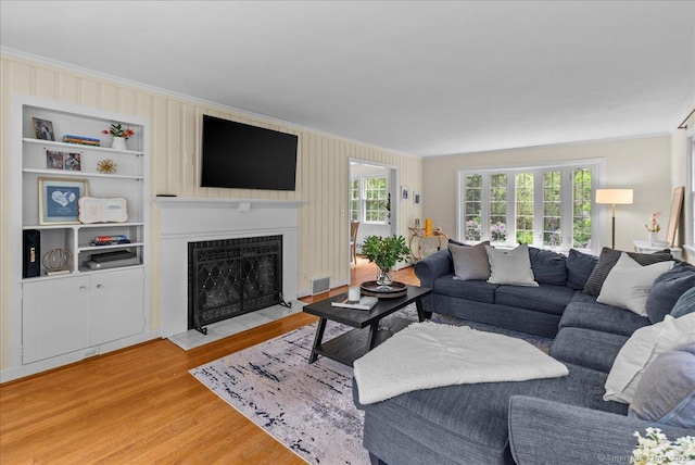 18 Hillcrest Rd, Manchester, CT 06040 - living room with ornamental molding, light wood finished floors, and a fireplace with flush hearth