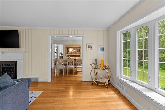 18 Hillcrest Rd, Manchester, CT 06040 - living room with crown molding, healthy amount of natural light, light wood-style floors, baseboards, and a fireplace
