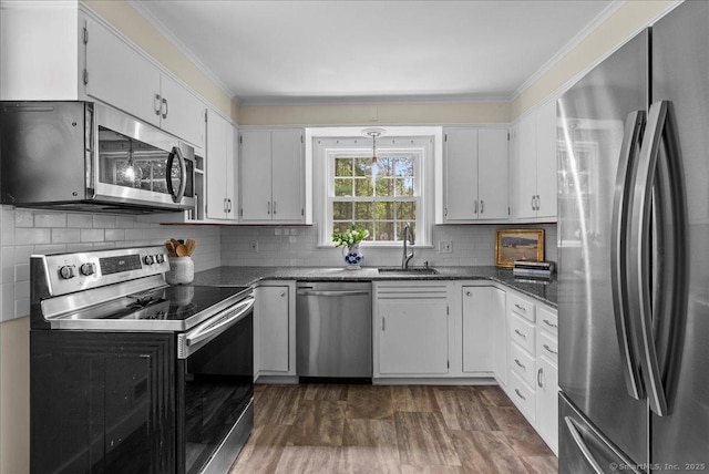 18 Hillcrest Rd, Manchester, CT 06040 - kitchen with appliances with stainless steel finishes, white cabinetry, crown molding, backsplash, and a sink