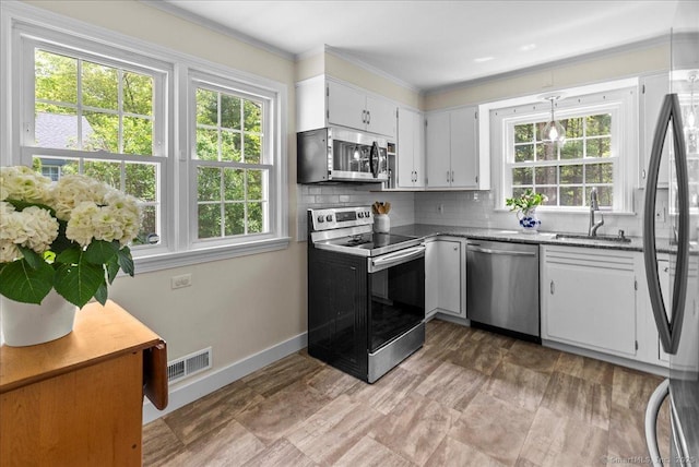 18 Hillcrest Rd, Manchester, CT 06040 - kitchen with appliances with stainless steel finishes, a sink, healthy amount of natural light, tasteful backsplash, and ornamental molding