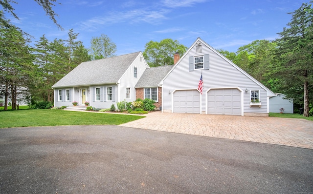258 New Cheshire Rd, Wallingford, CT 06492 - cape cod house with driveway, a chimney, a shingled roof, a front yard, and a garage