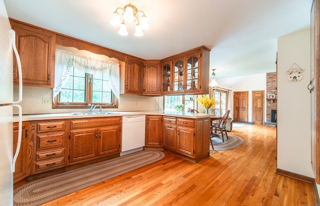 258 New Cheshire Rd, Wallingford, CT 06492 - kitchen with white appliances, brown cabinetry, healthy amount of natural light, and light wood finished floors
