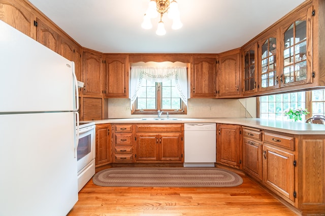 258 New Cheshire Rd, Wallingford, CT 06492 - kitchen with white appliances, healthy amount of natural light, brown cabinets, and light countertops
