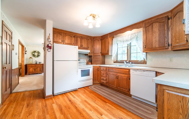 258 New Cheshire Rd, Wallingford, CT 06492 - kitchen featuring white appliances, under cabinet range hood, brown cabinetry, light countertops, and light wood-style floors